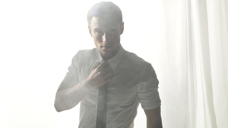 Man Adjusting Tie — White