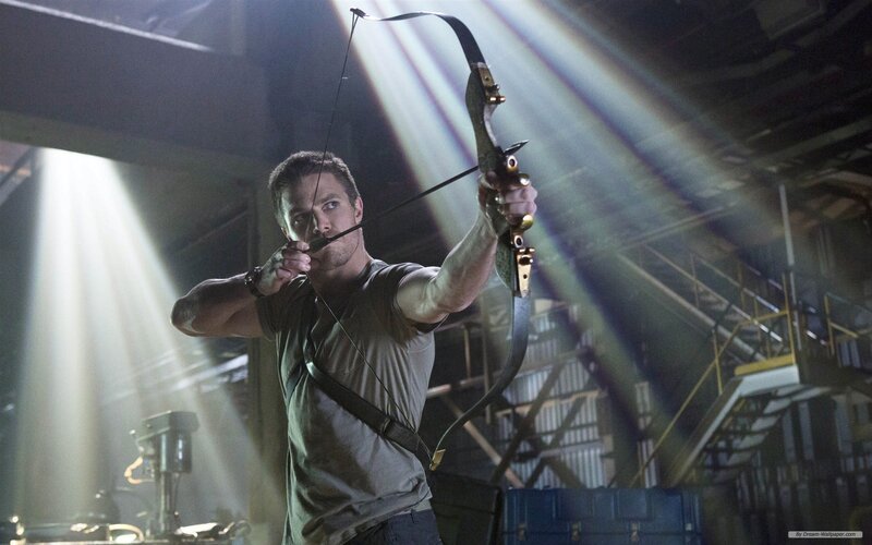 man aiming bow and arrow
