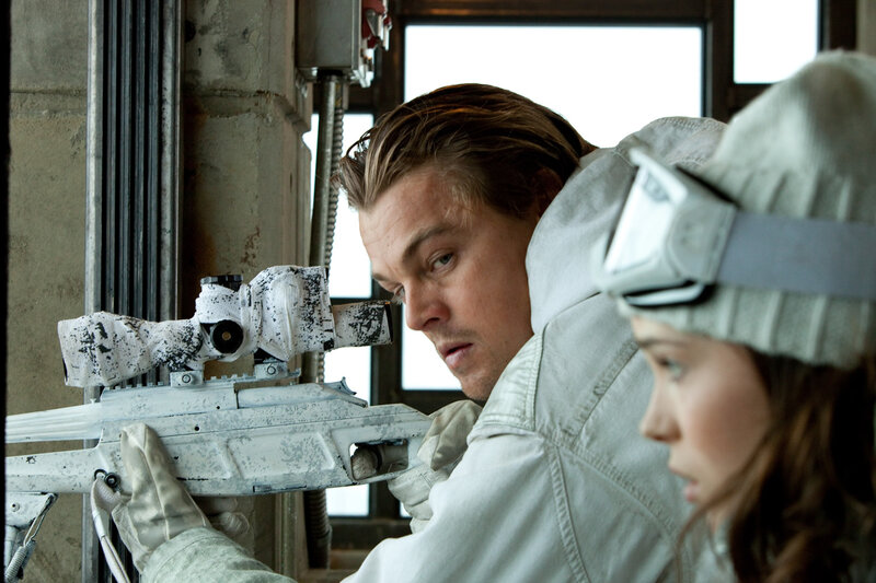Man aiming sniper rifle with woman