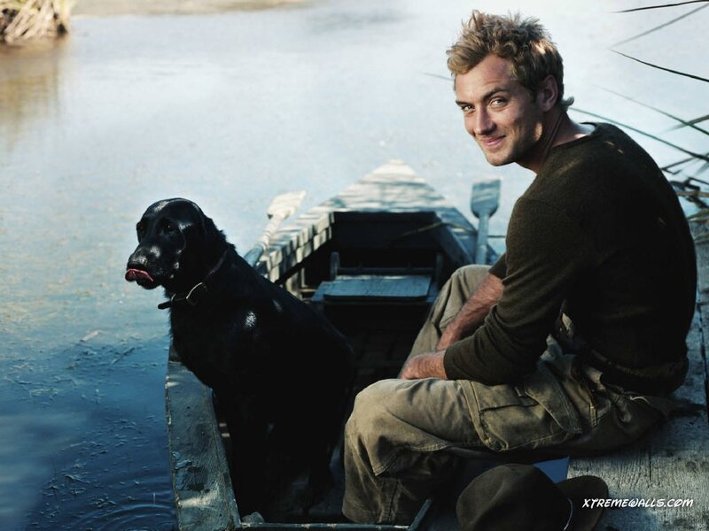Man and Black Dog in Boat