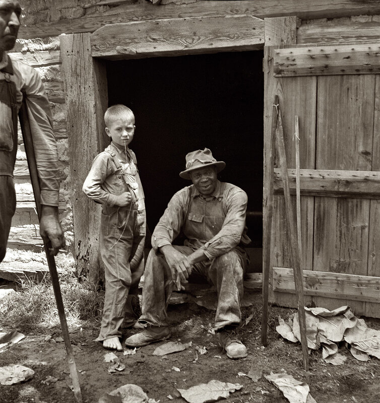Man and boy outside cabin