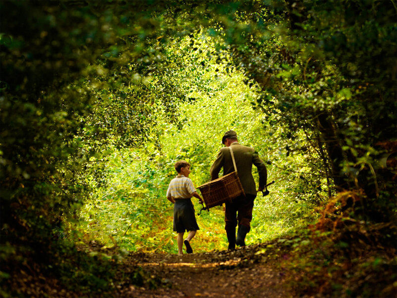 Man and boy walking in forest