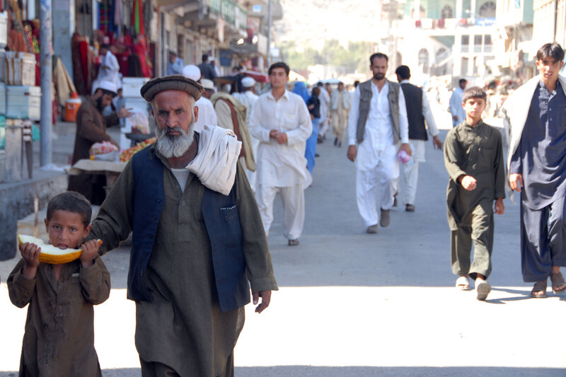 Man and boy walking in market