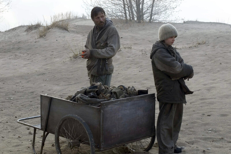 Man and boy with cart in desert