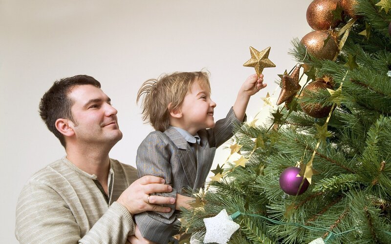 Man and Child Decorating Tree