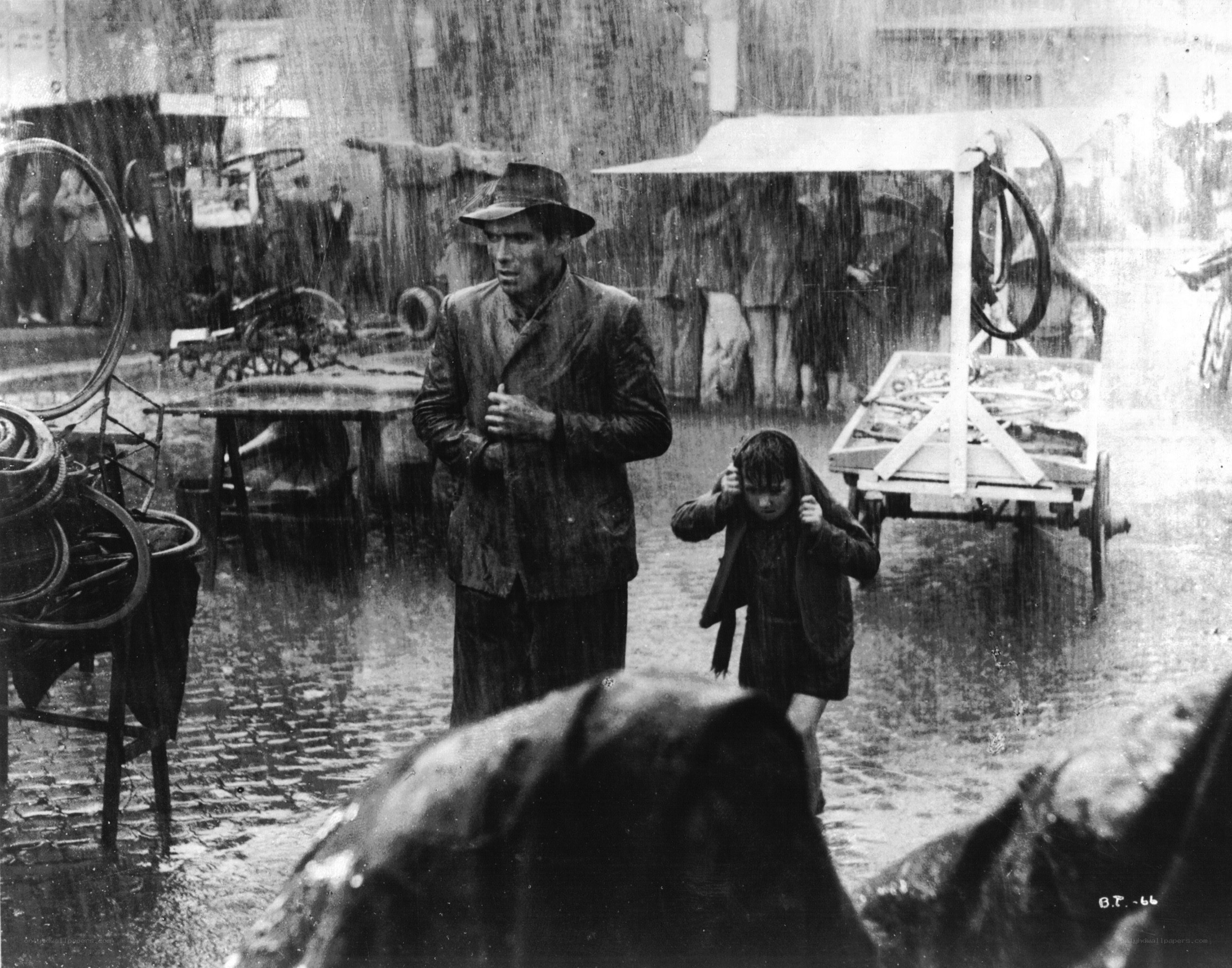 Man and child in rain