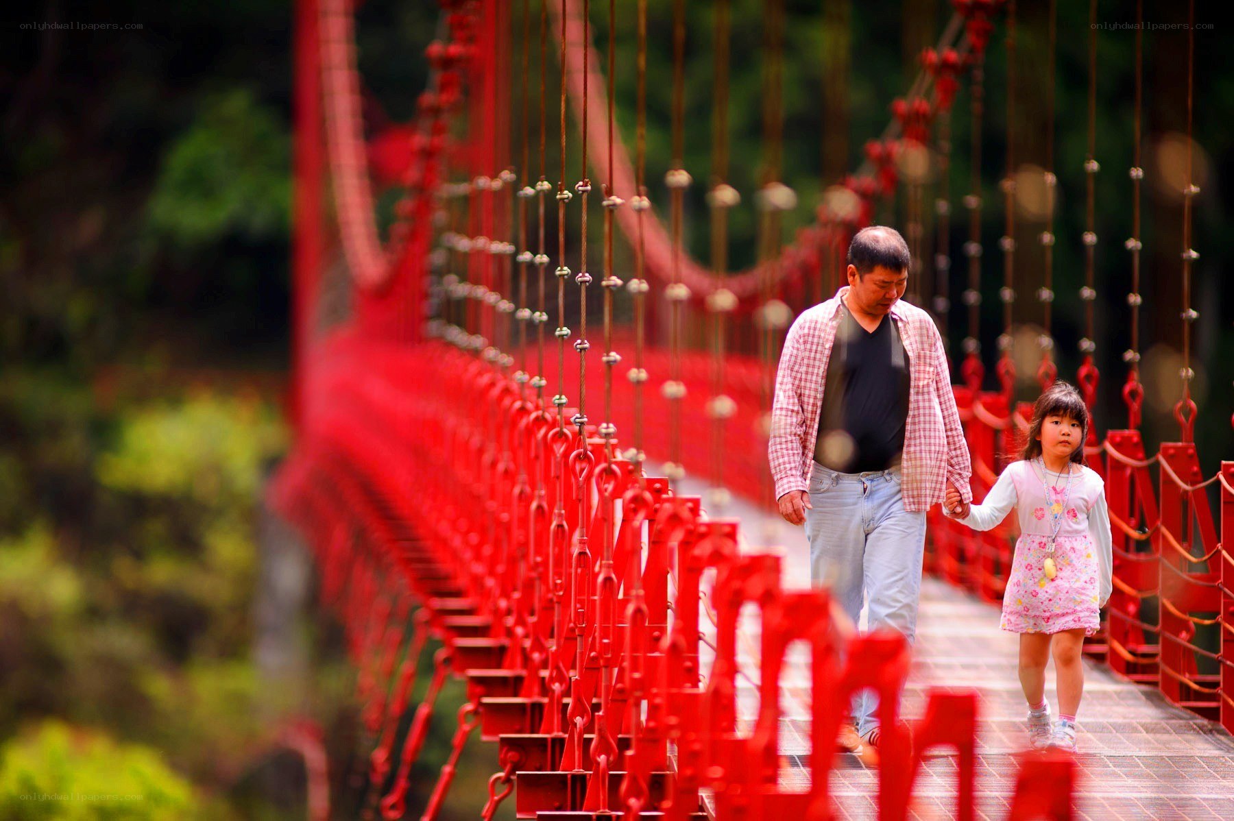 Man and child on red bridge
