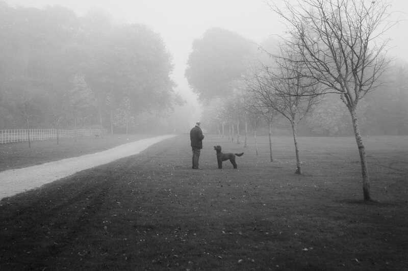 Man and Dog in Park — Black