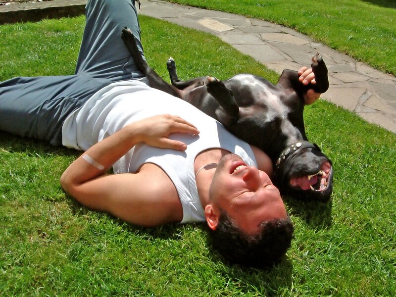 Man and dog relaxing on grass