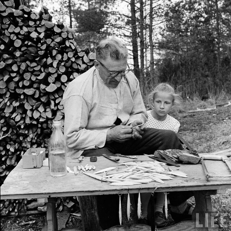 man and girl making fishing lures