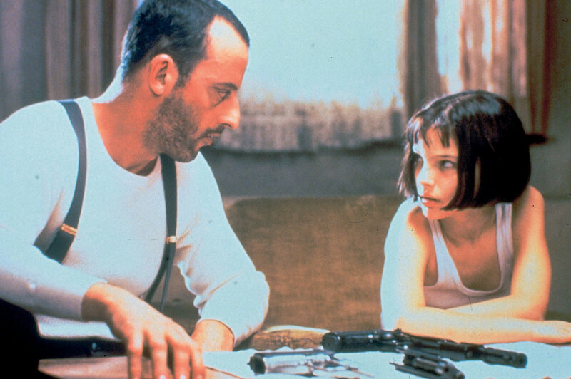 Man and girl with guns on table