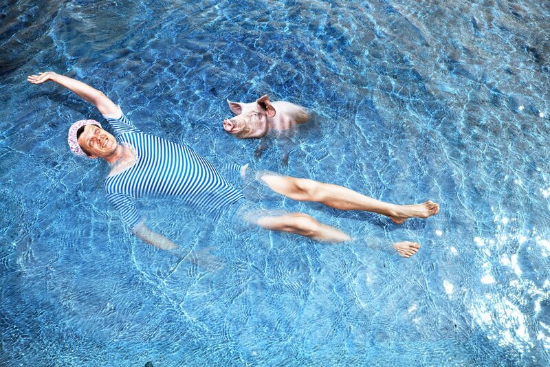 Man and pig floating in pool