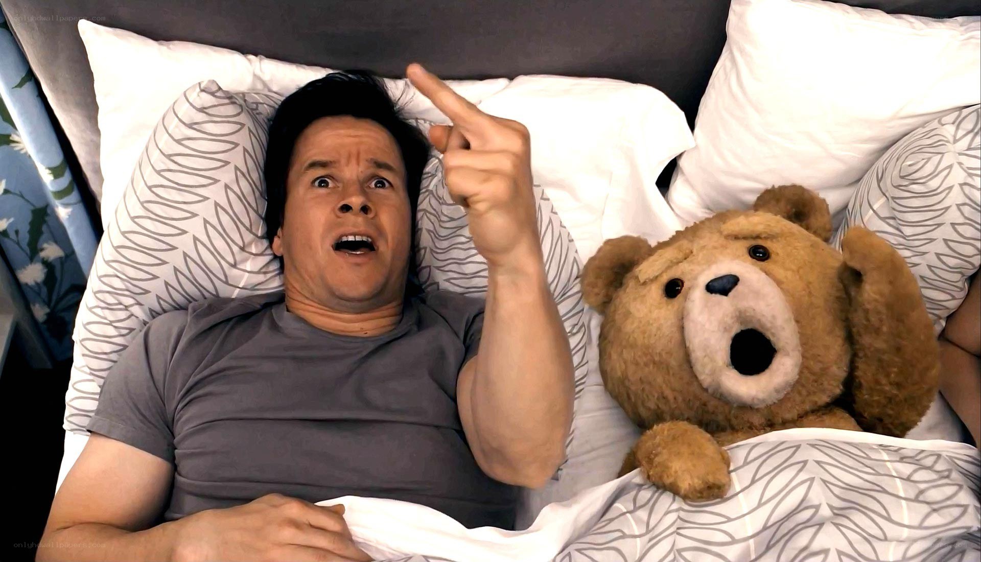 Man and teddy bear in bed