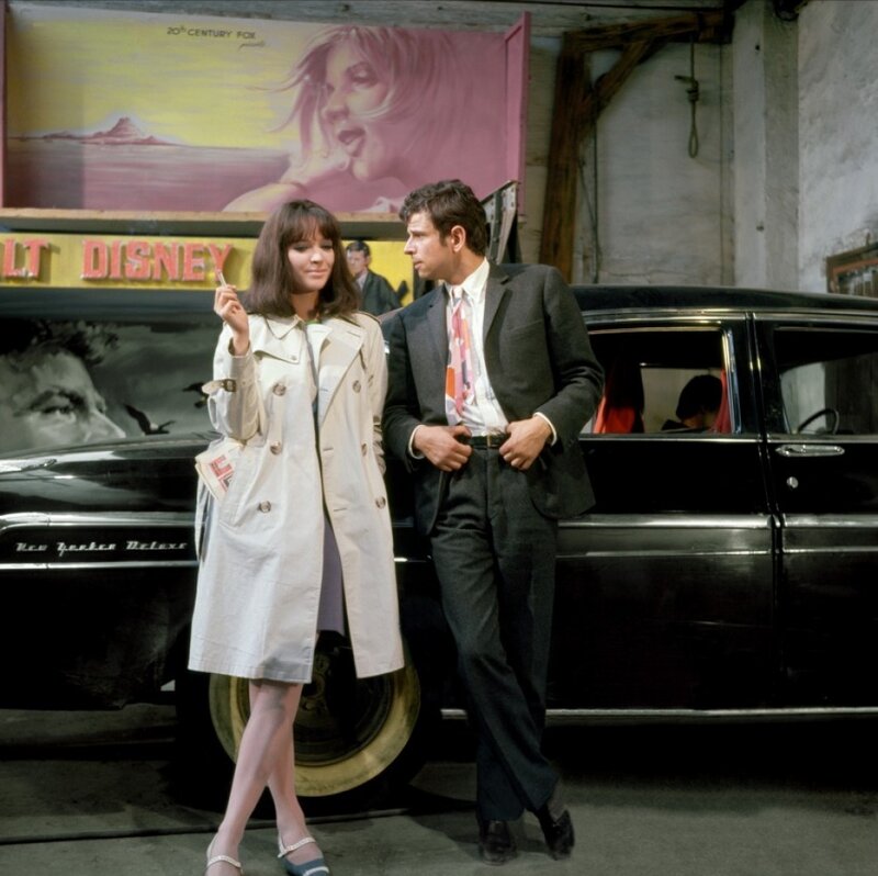 Man and woman by a car
