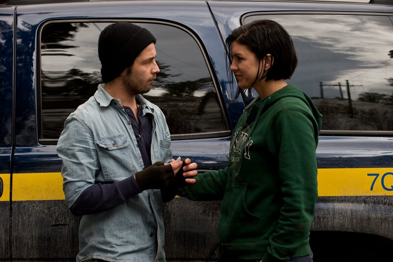 Man and woman by a van