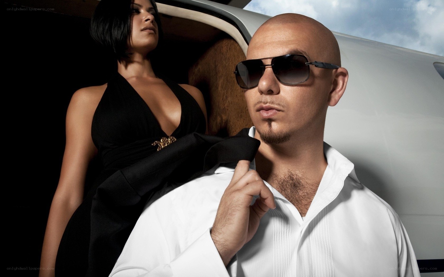 Man and woman by luxury car