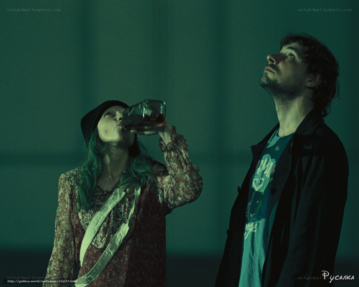 Man and woman drinking from bottle