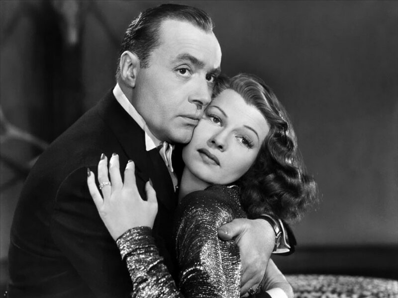 Man and Woman Embracing — Black, Dramatic, Photograph, Suit, Dress, Ring