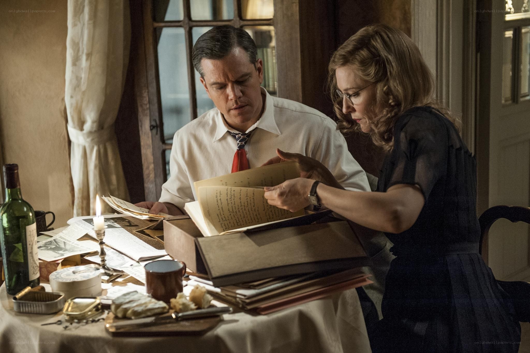 man and woman examining documents