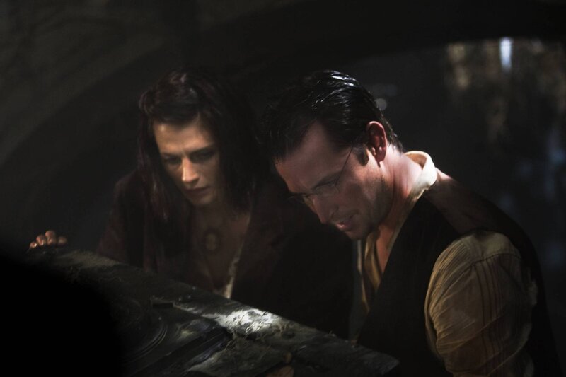 man and woman examining object