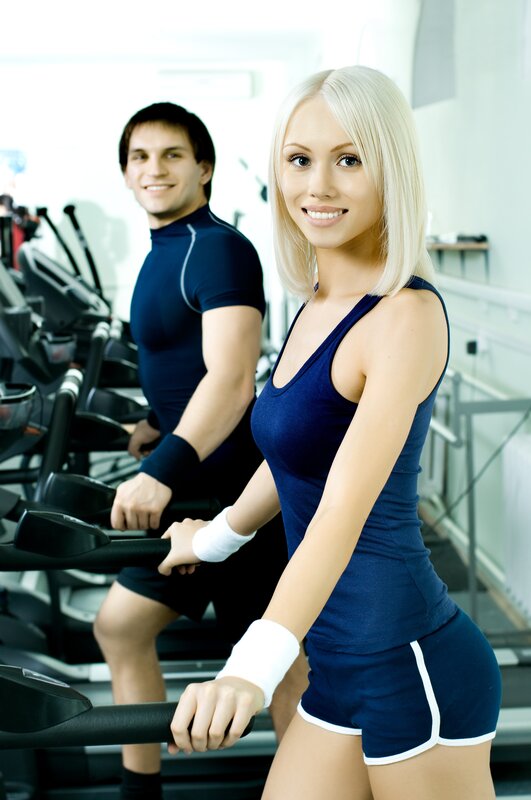 Man and woman exercising in gym