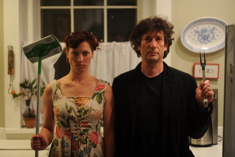 Man and woman holding cleaning tools
