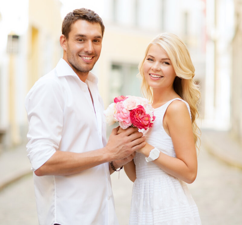 Man and Woman Holding Flowers — White