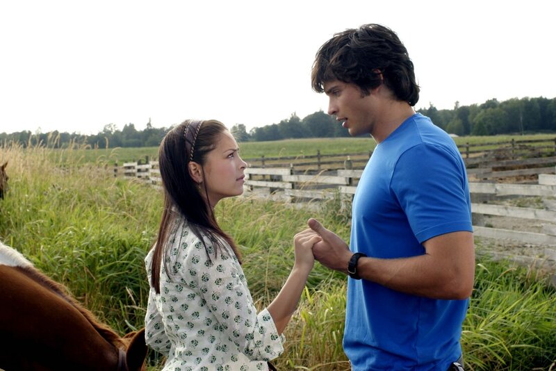 man and woman holding hands in field