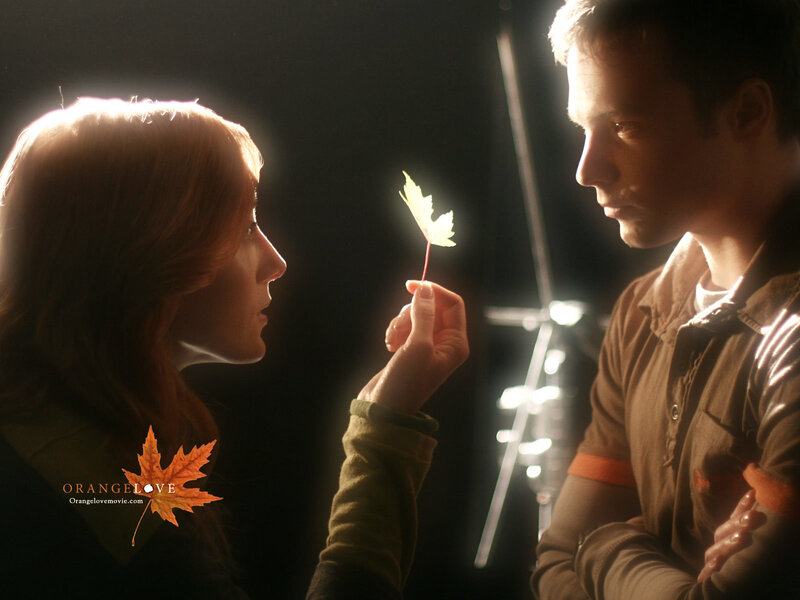 Man and Woman Holding Leaf