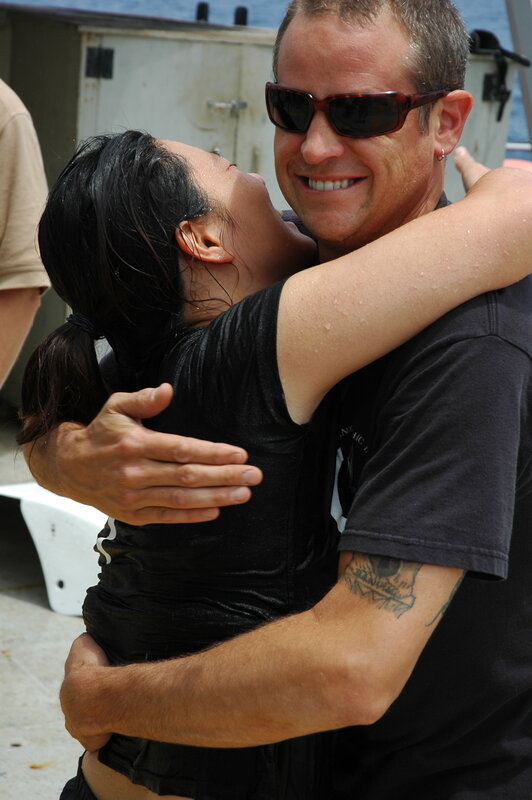 Man and woman hugging on boat