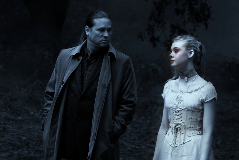 man and woman in dark forest