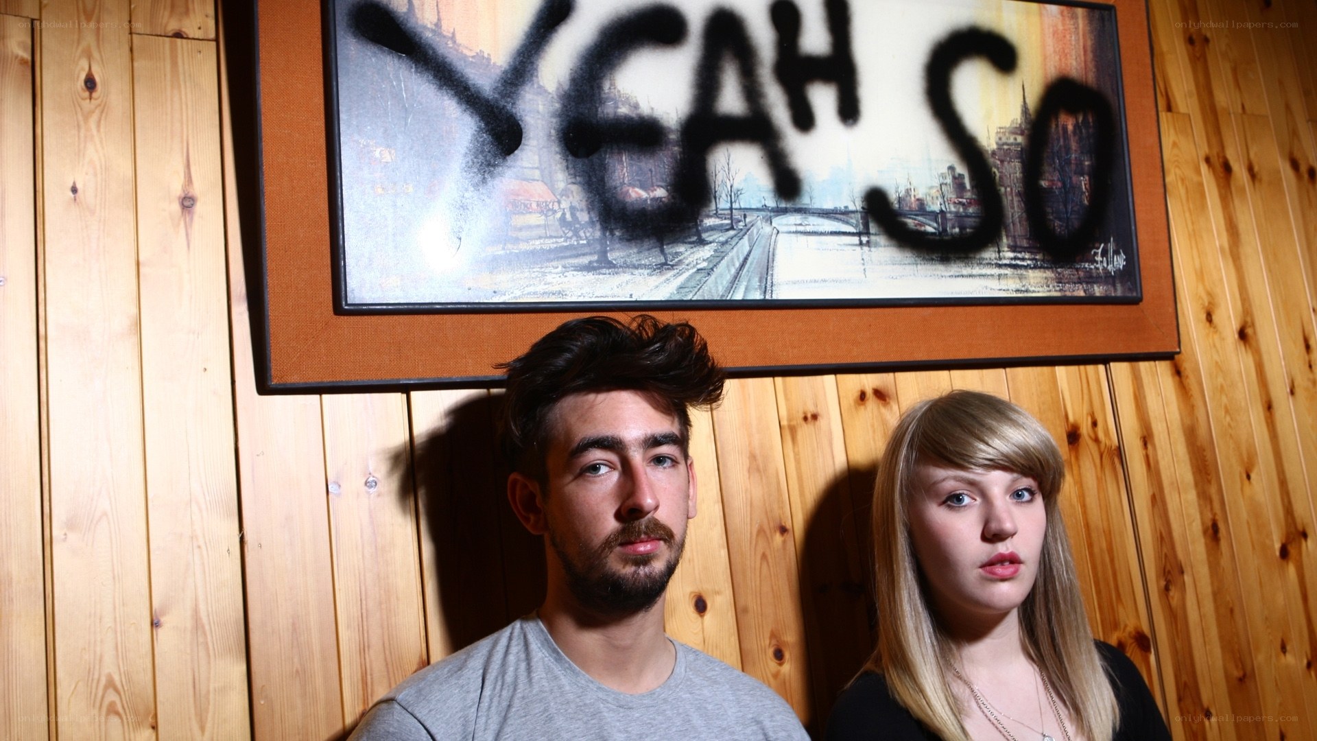 man and woman in front of graffiti art