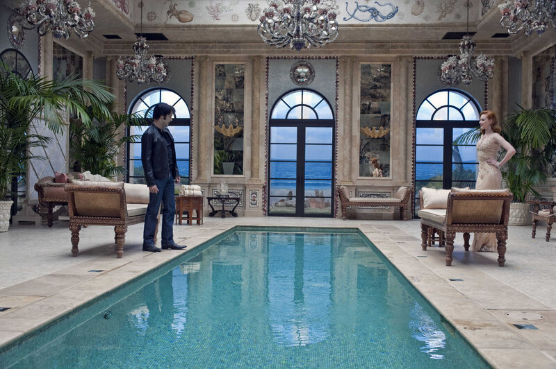 Man and woman in grand indoor pool room