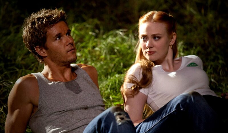 man and woman in grass