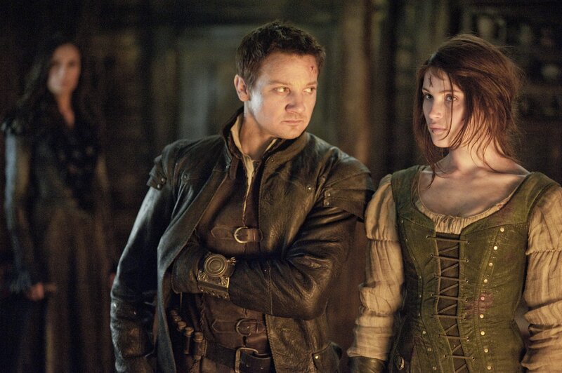 Man and Woman in Medieval Clothing — Brown, Dramatic, Photograph, Background Figure