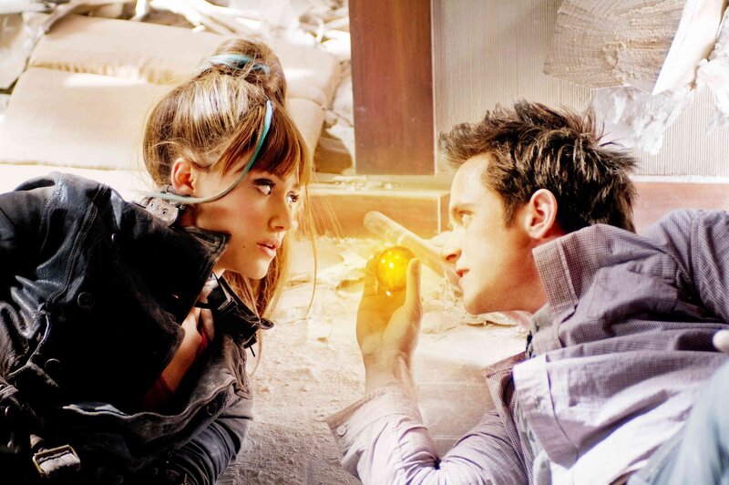 Man and woman in rubble with glowing orb