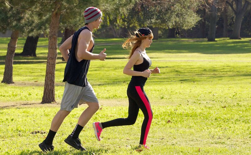 Man and Woman Jogging — Green