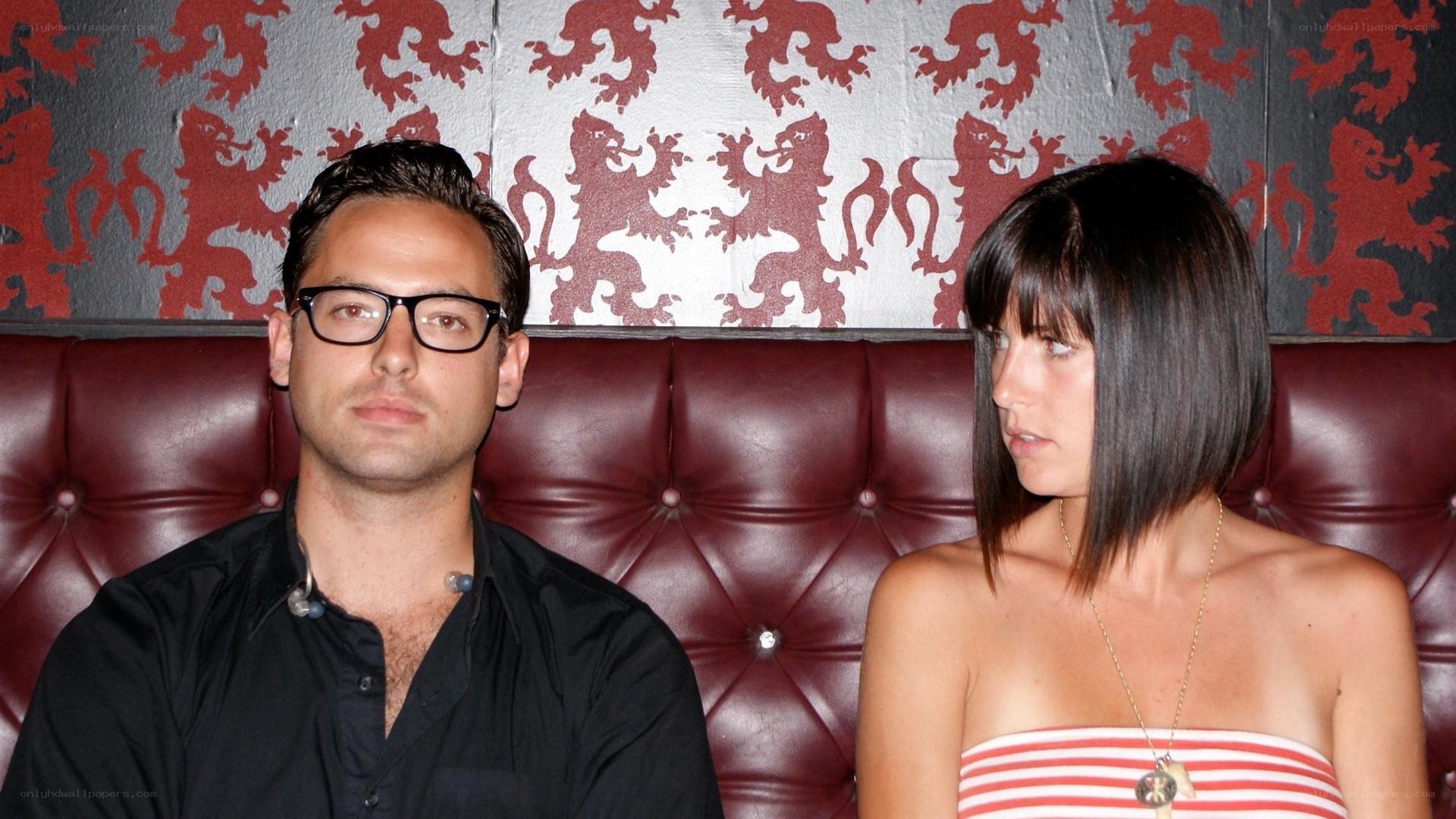 Man and woman on a red couch