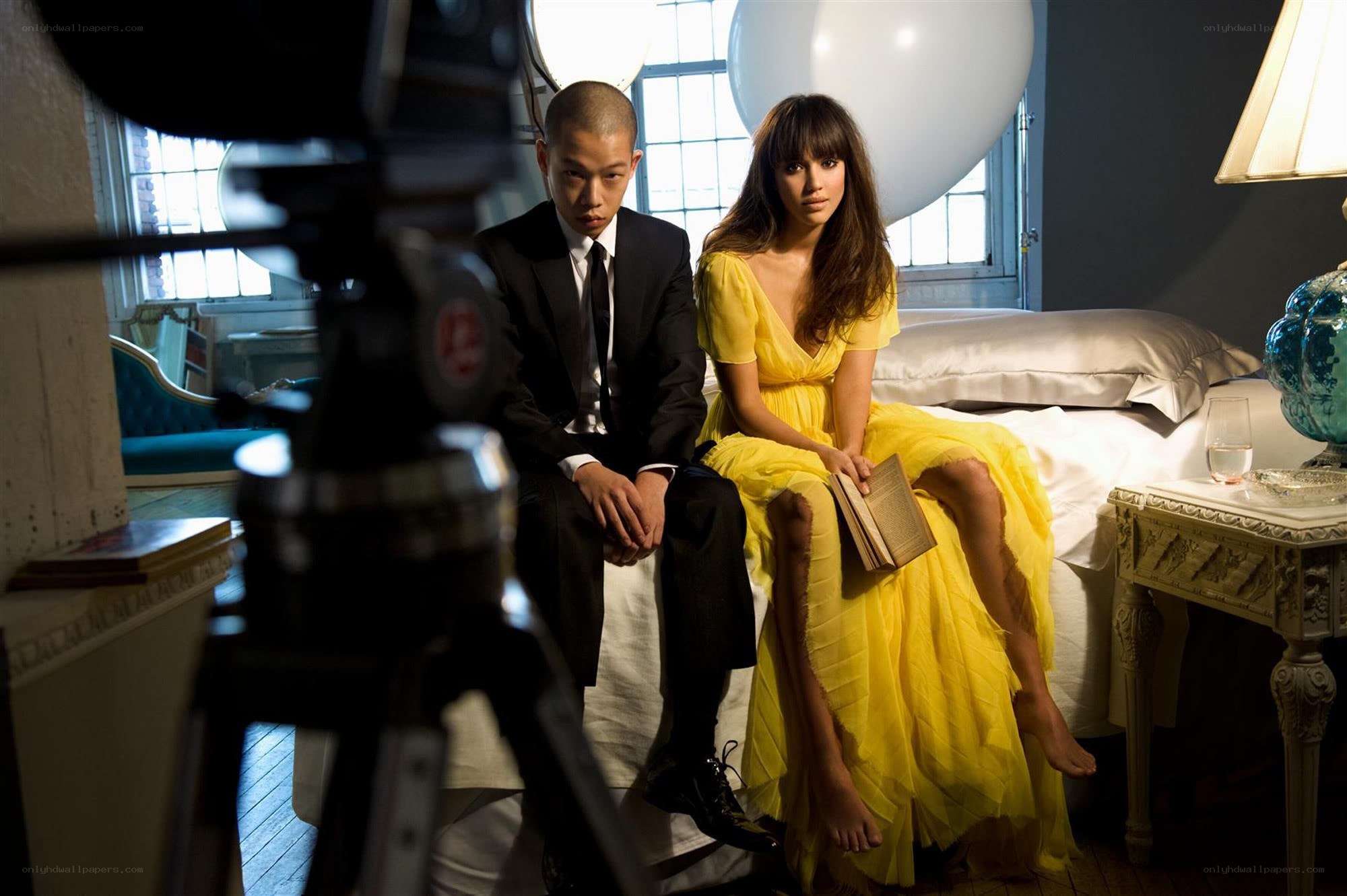 Man and woman on bed with camera