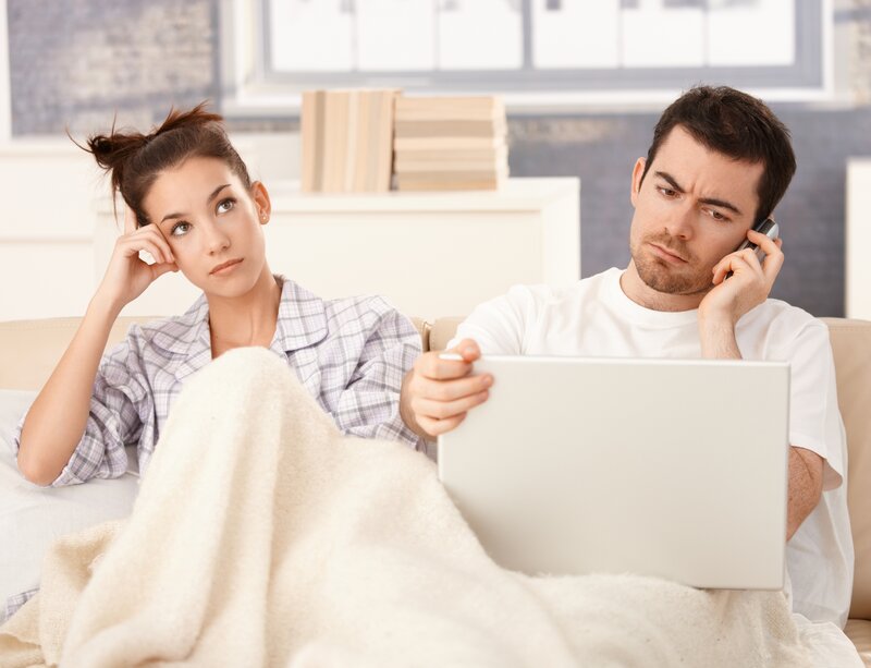 Man and Woman on Couch — White, Distracted