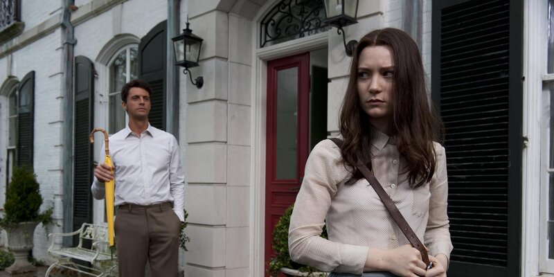 man and woman outside house