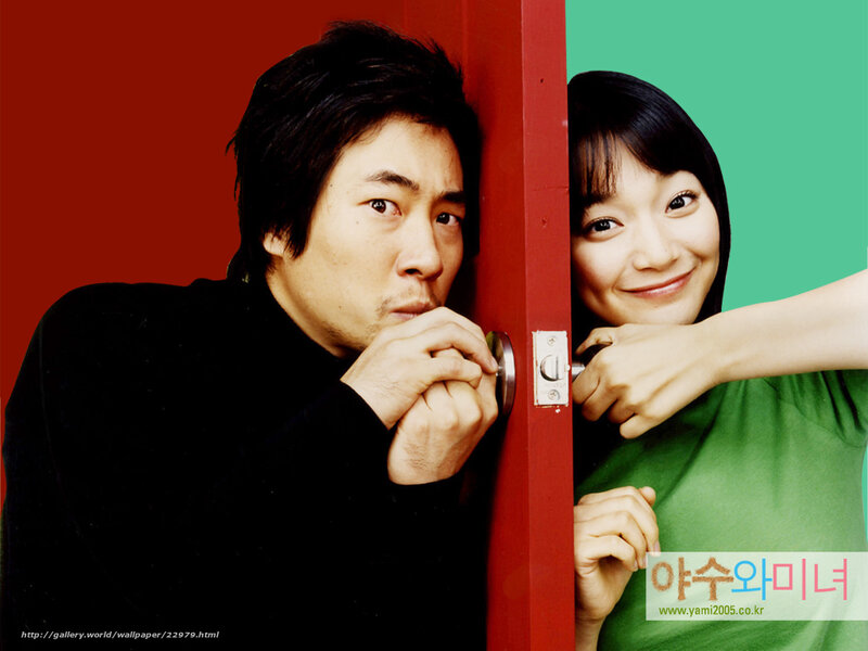 man and woman peeking from door