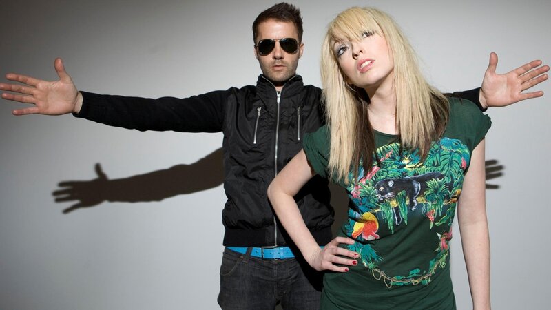 man and woman posing with arms outstretched