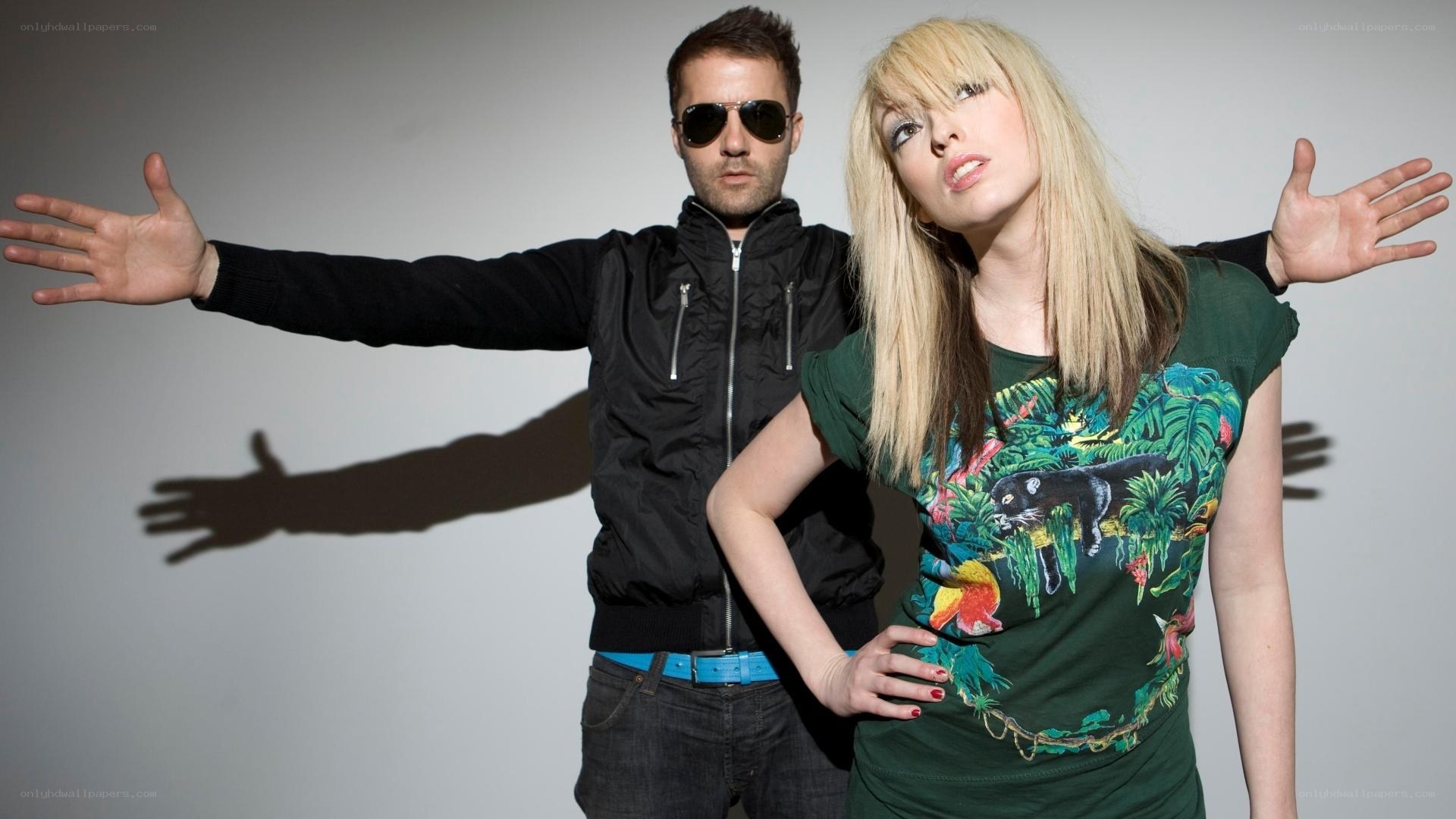 man and woman posing with arms outstretched
