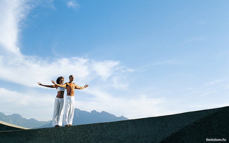 Man and Woman Practicing Yoga