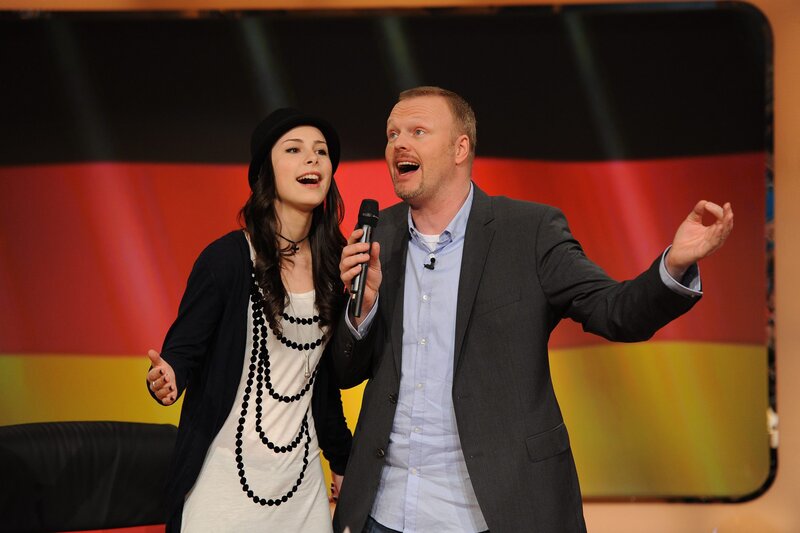 Man and woman singing on stage