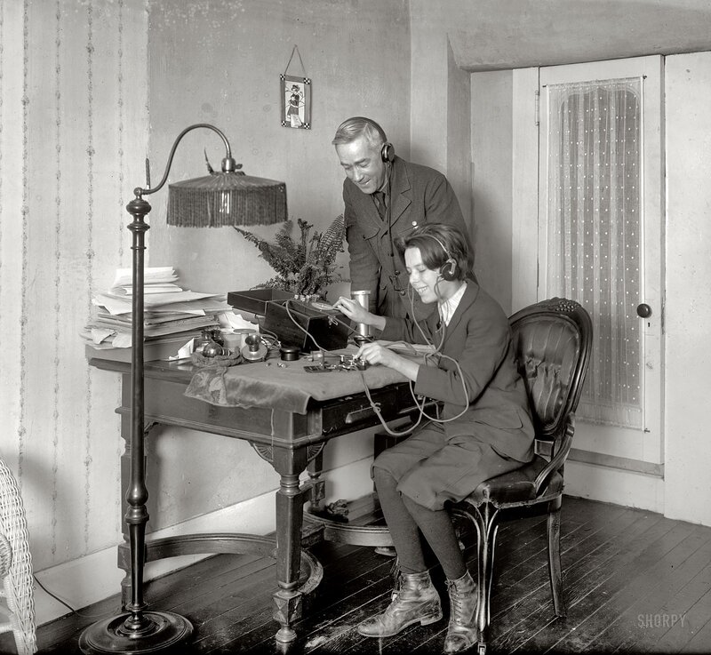 Man and woman using early radio equipment