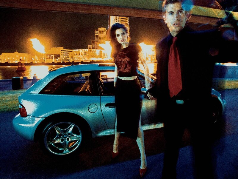 Man and woman with car at night