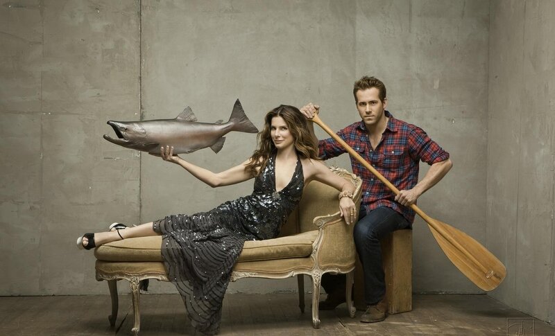 Man and woman with fish and paddle