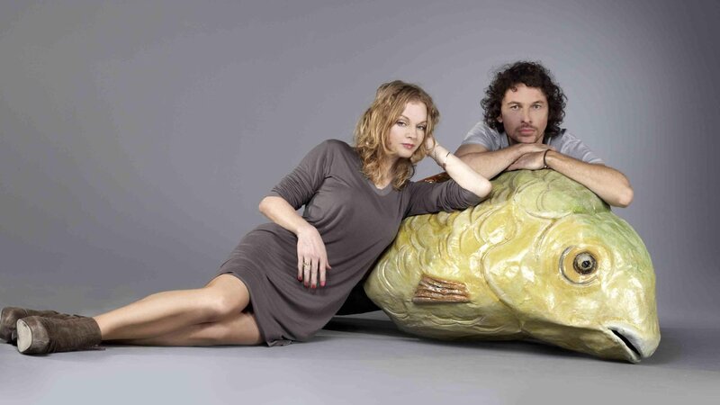 man and woman with fish sculpture